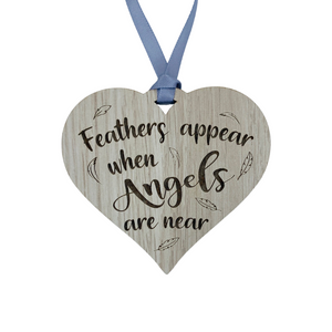 A hanging heart plaque featuring the phrase "Angels"
