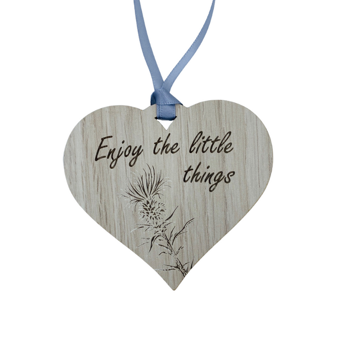 A hanging heart plaque featuring the phrase 