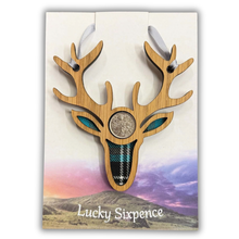 Load image into Gallery viewer, Lucky Sixpence in the centre of a stag wooden plaque and tartan background