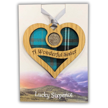 Load image into Gallery viewer, Wooden Plaque in the shape of a heart with lucky sixpence in the centre and 'my wonderful sister' text