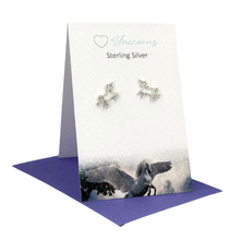 Load image into Gallery viewer, Unicorn-themed silver earrings on a branded card with a purple base