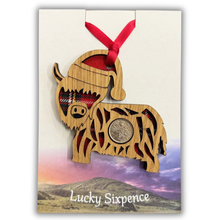 Load image into Gallery viewer, Christmas Coo Lucky Sixpence on an oak veneered surround and a Royal Stewart tartan background