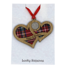 Load image into Gallery viewer, Wooden Plaque shaped with two hearts joined with lucky sixpence and tartan background, engraved with Hugs & Kisses