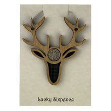 Load image into Gallery viewer, Lucky Sixpence in the centre of a stag wooden plaque and tartan background
