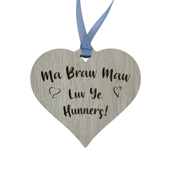 A hanging heart plaque featuring the phrase 