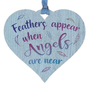 A hanging heart plaque featuring the phrase "Angels"