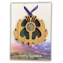 Load image into Gallery viewer, Wooden Plaque in the shape of a thistle with tartan background and lucky sixpence in the centre

