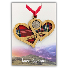 Load image into Gallery viewer, Wooden Plaque shaped with two hearts joined with lucky sixpence and tartan background
