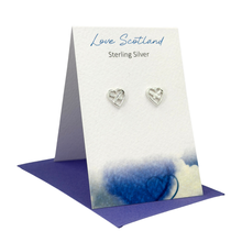 Load image into Gallery viewer, Heart-shaped silver earrings on a 'Love Scotland' branded card with a blue card base.
