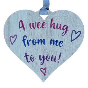 A hanging heart plaque featuring the phrase "A Wee Hug"