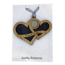 Load image into Gallery viewer, Wooden Plaque shaped with two hearts joined with lucky sixpence and tartan background, engraved with Hugs &amp; Kisses
