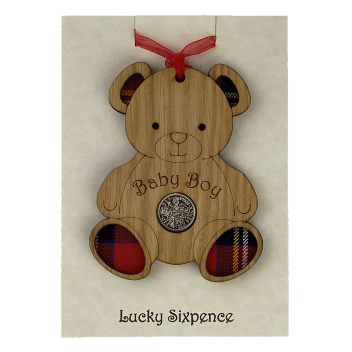 Wooden Plaque in the shape of a bear with tartan feet and lucky sixpence in the centre