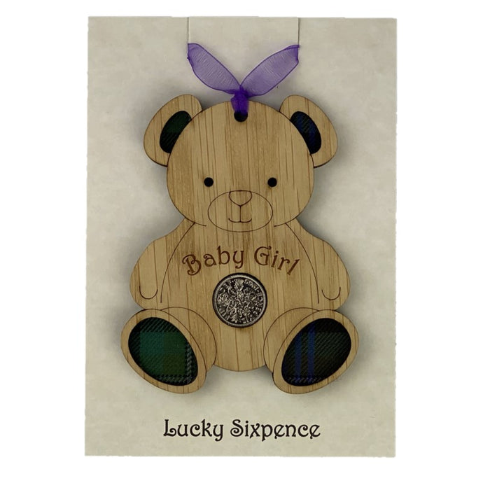 Wooden Plaque in the shape of a bear with tartan feet and lucky sixpence in the centre
