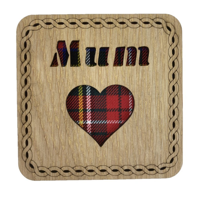 A wooden square coaster with a tartan background featuring the word 
