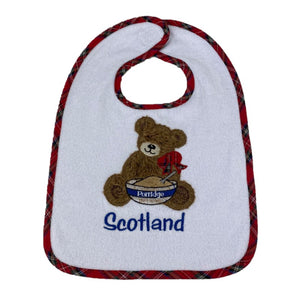 Baby Gift Bib with tartan embroidery and textured bear character on the front with a bowl of porridge and 'Scotland' text