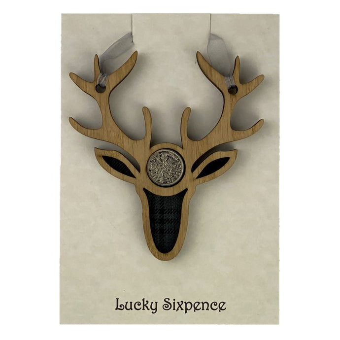 Lucky Sixpence in the centre of a stag wooden plaque and tartan background