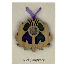 Load image into Gallery viewer, Wooden Plaque in the shape of a thistle with tartan background and lucky sixpence in the centre
