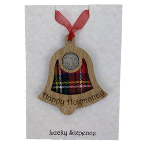Happy Hogmanay Bell Lucky Sixpence on an oak veneered surround and a Royal Stewart tartan background