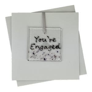 White Handmade Card with Fused Glass Art in the centre that says 'You're engaged'